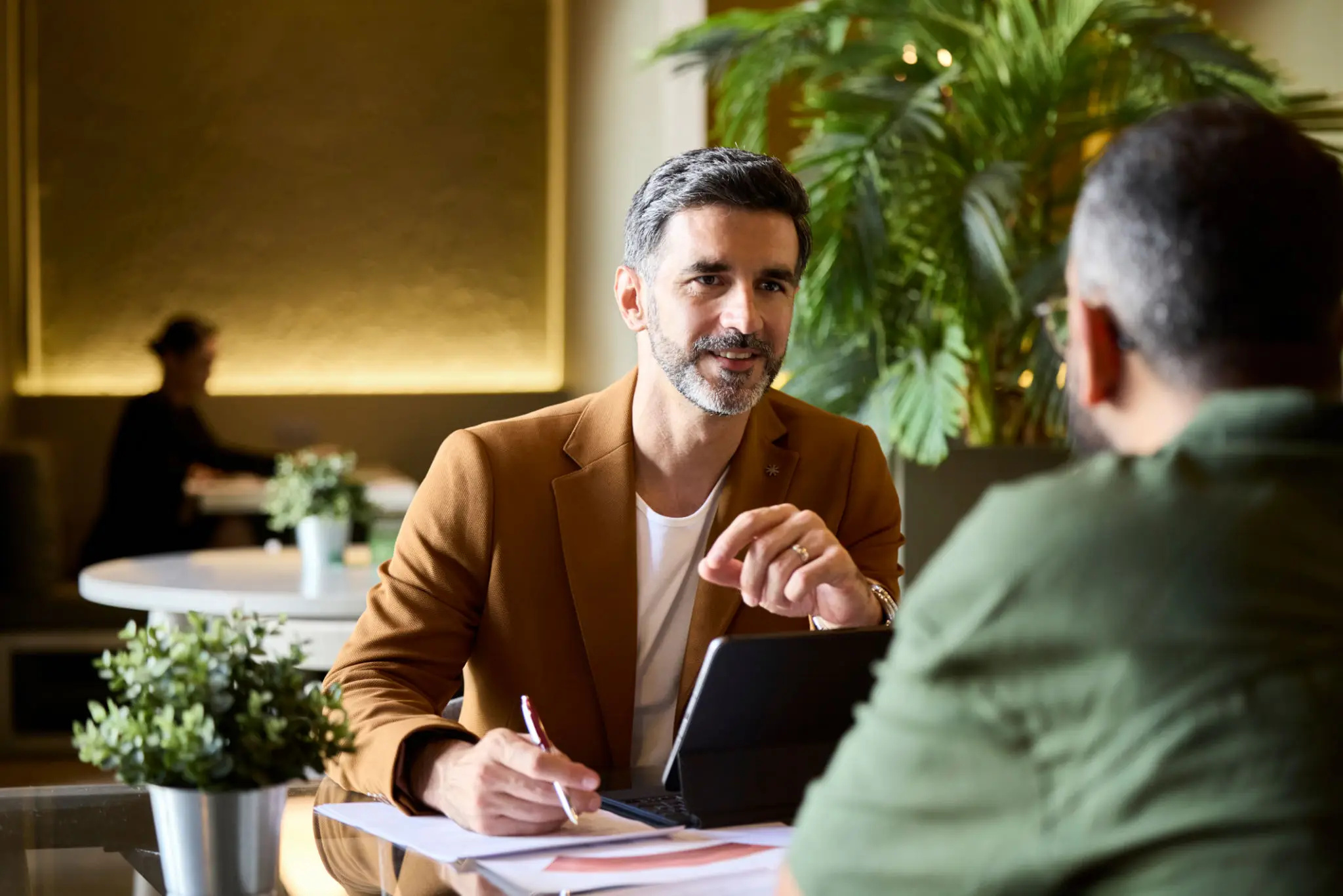 Advisor using a tablet to review client meeting notes and next-best actions
