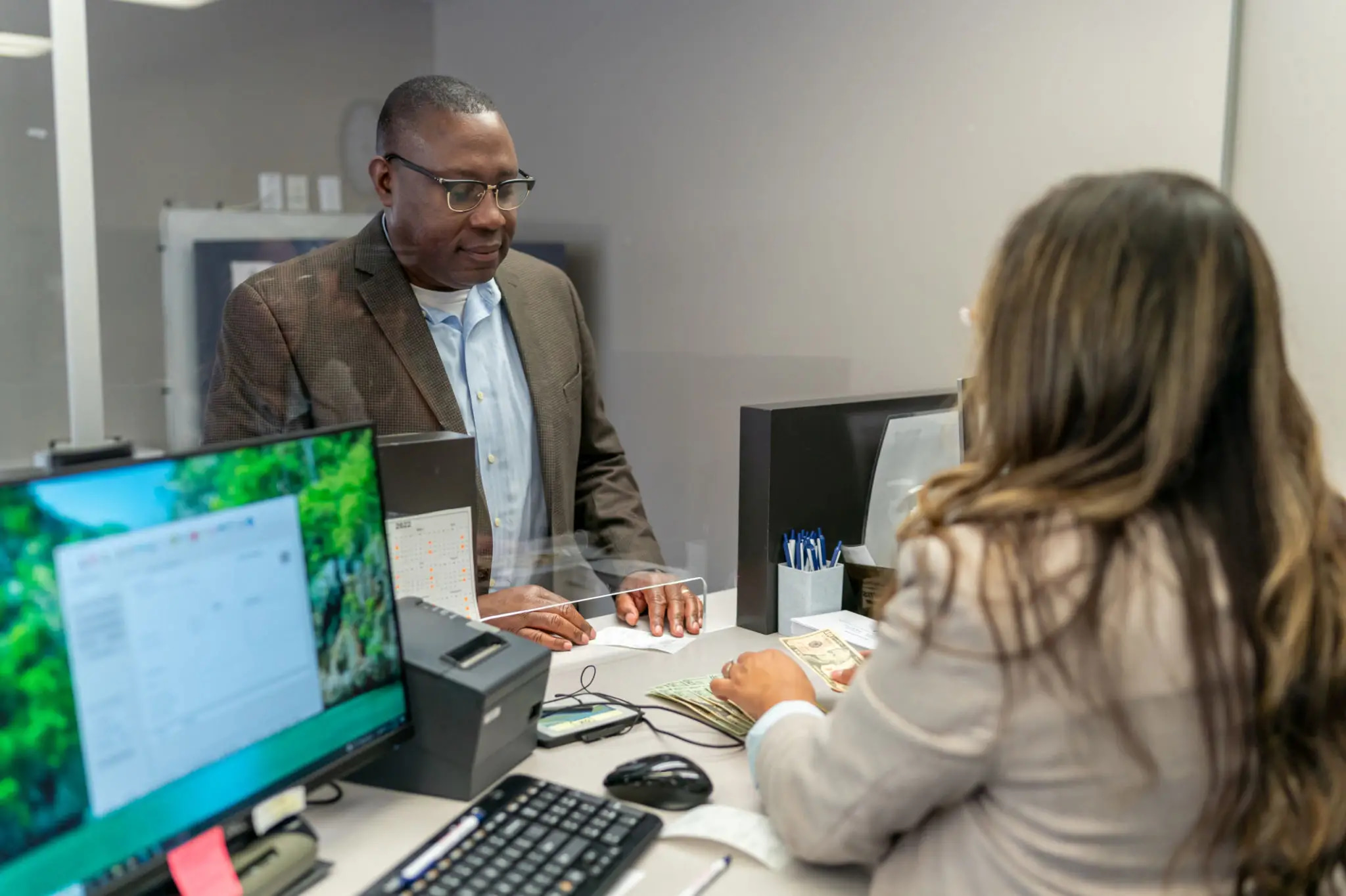 Credit union member receiving service at a branch teller station