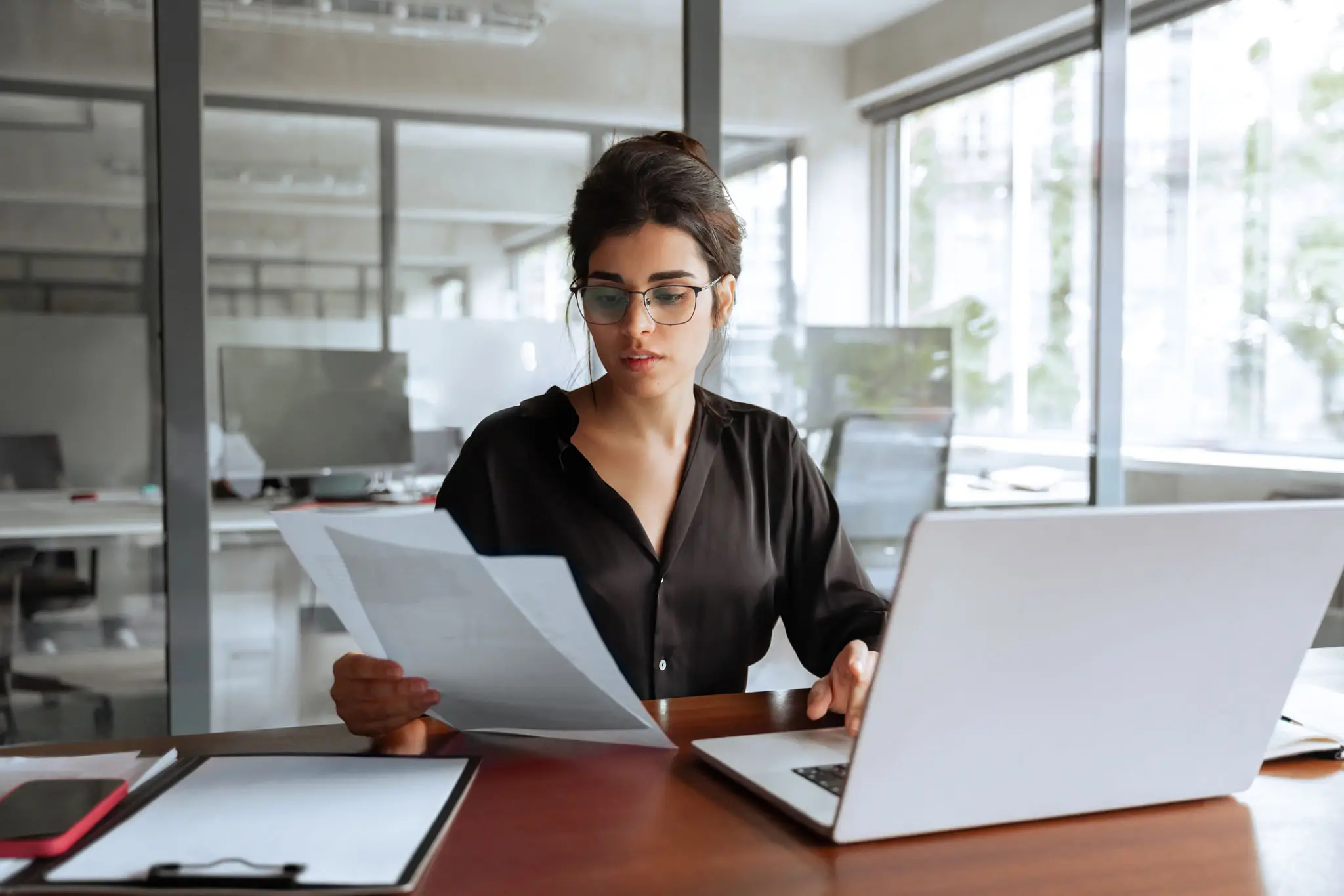 Bank compliance specialist reviewing financial documentation